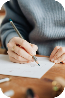 Person sitting at desk Writing with pencil